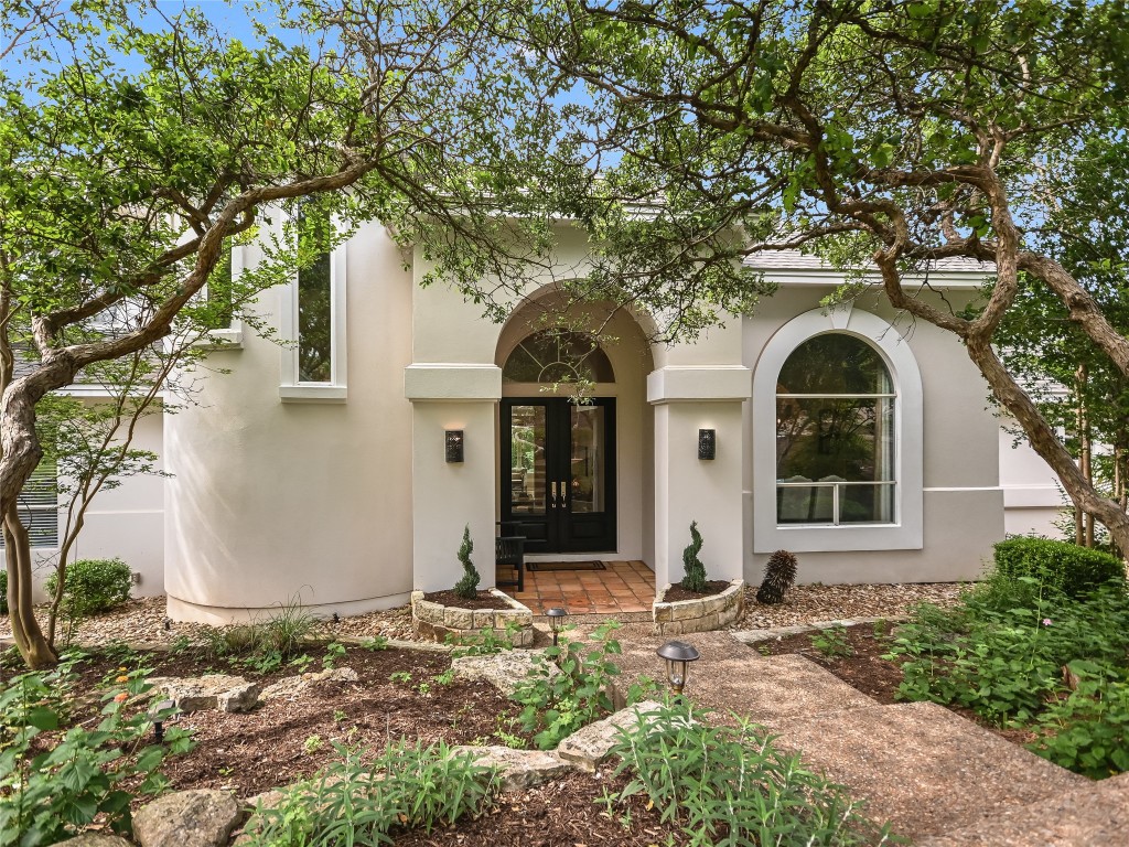 a front view of a house with garden