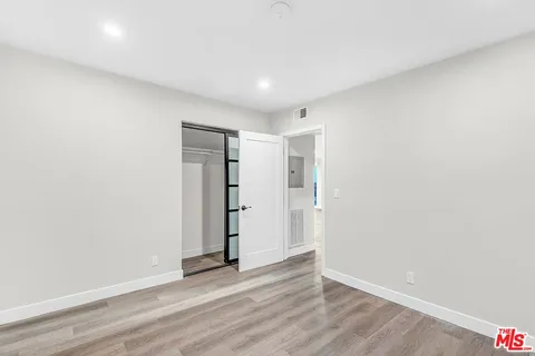 an empty room with wooden floor