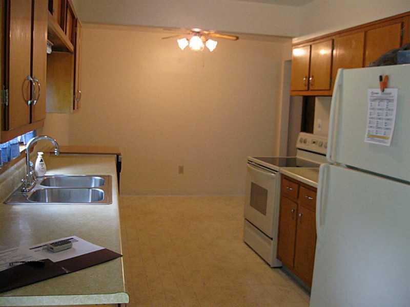 167 Broadview Road New Stanton, PA 15639 - Photo 6 of 11 Kitchen. Looking into the kitchen from the back door. Far space is the eating nook. Window overlooking the back yard. Stove and portable dishwasher.