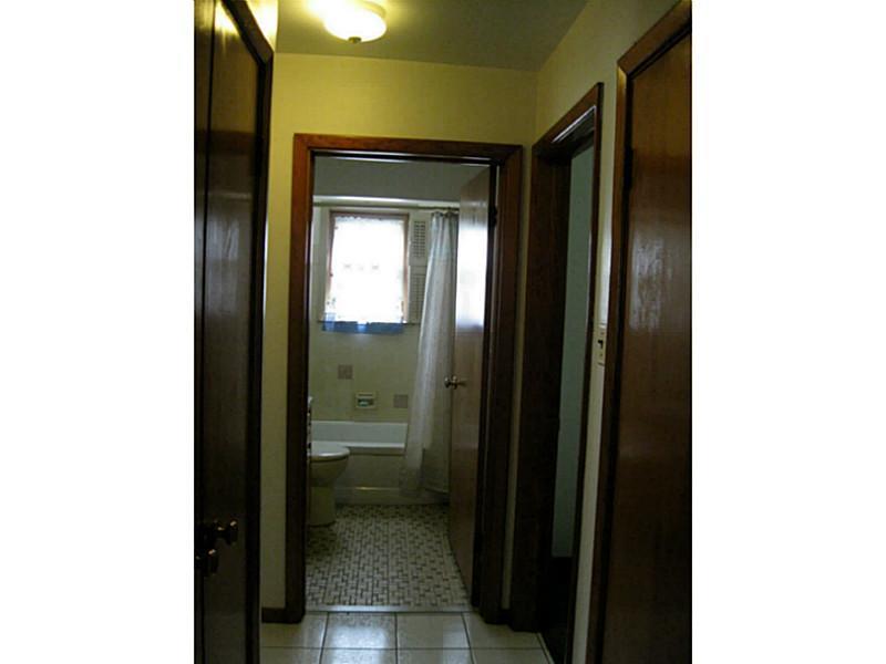 167 Broadview Road New Stanton, PA 15639 - Photo 9 of 11 Full Bath. and hallway. Features closet to left and door to right leads down to the basement.