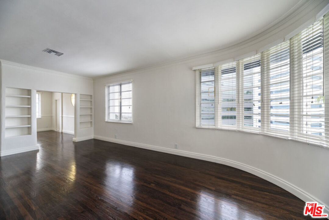 9237 Doheny Road West Hollywood, CA 90069 - Photo 1 of 14 a view of an empty room with wooden floor and a window
