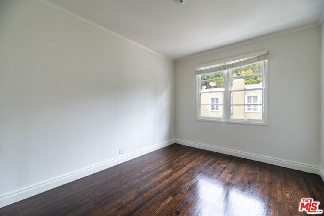 9237 Doheny Road West Hollywood, CA 90069 - Photo 11 of 14 a view of an empty room with wooden floor and a window