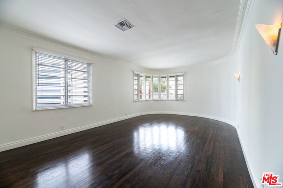 9237 Doheny Road West Hollywood, CA 90069 - Photo 4 of 14 a view of an empty room with wooden floor and a window