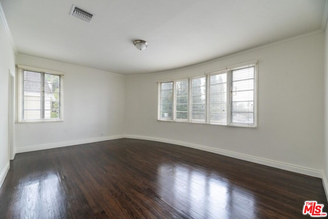 9237 Doheny Road West Hollywood, CA 90069 - Photo 9 of 14 a view of an empty room with wooden floor and a window