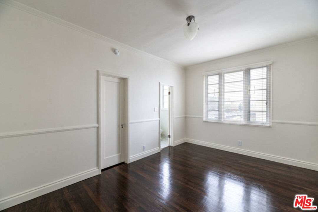 9237 Doheny Road West Hollywood, CA 90069 - Photo 10 of 14 an empty room with wooden floor and windows
