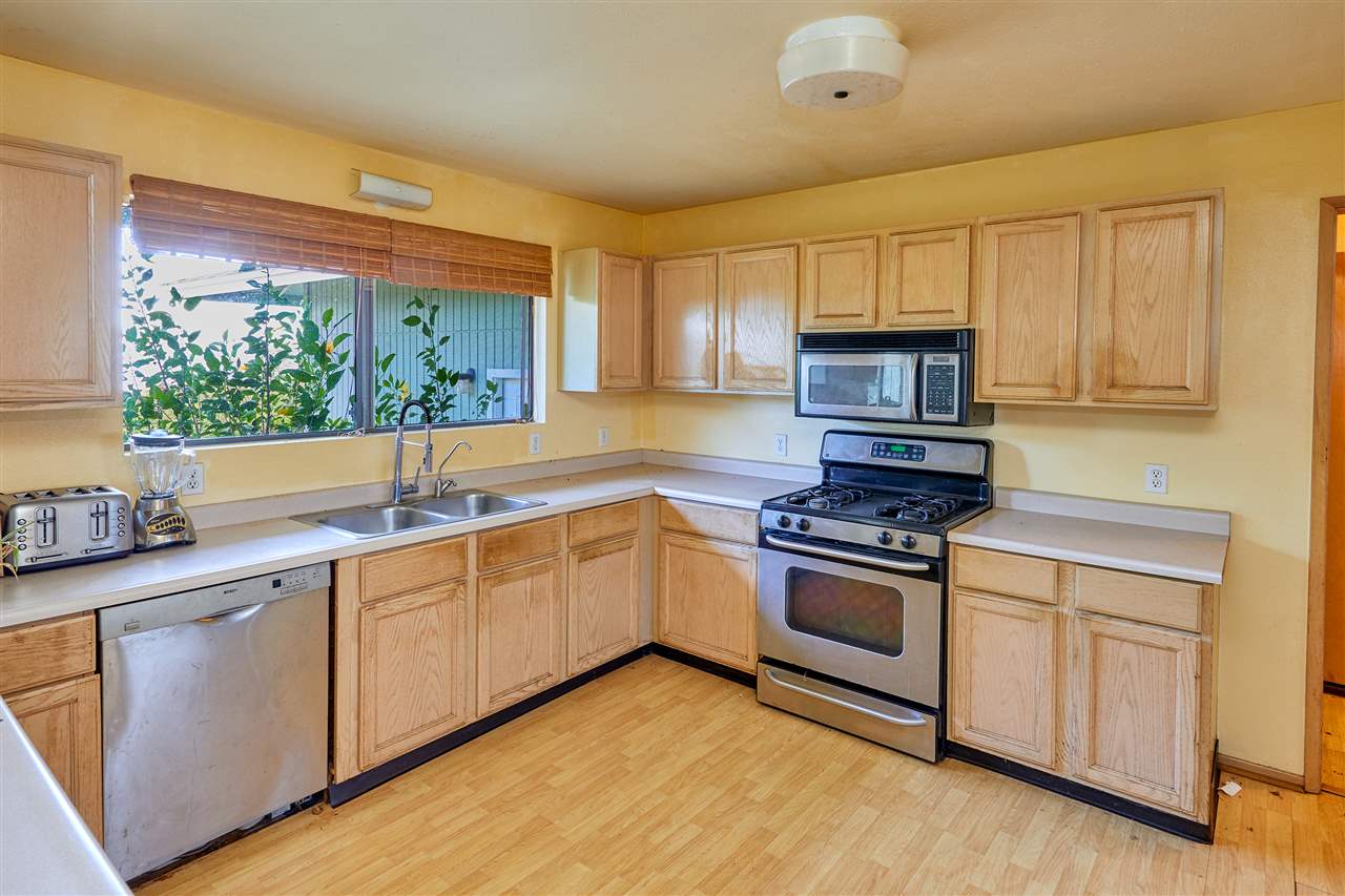5 Piliwale Road Kula, HI 96790 - Photo 3 of 22 a kitchen with stainless steel appliances white cabinets a sink and a stove