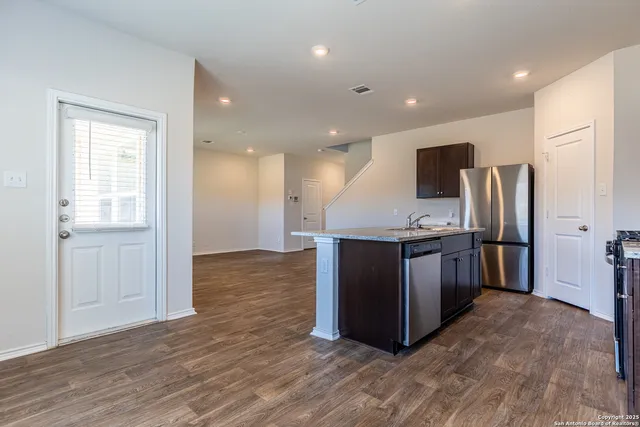 a view of kitchen with refrigerator microwave and wooden floor