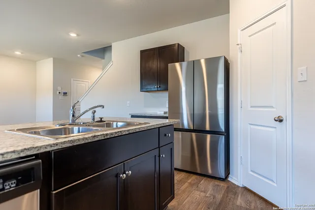 a kitchen with a refrigerator and a sink
