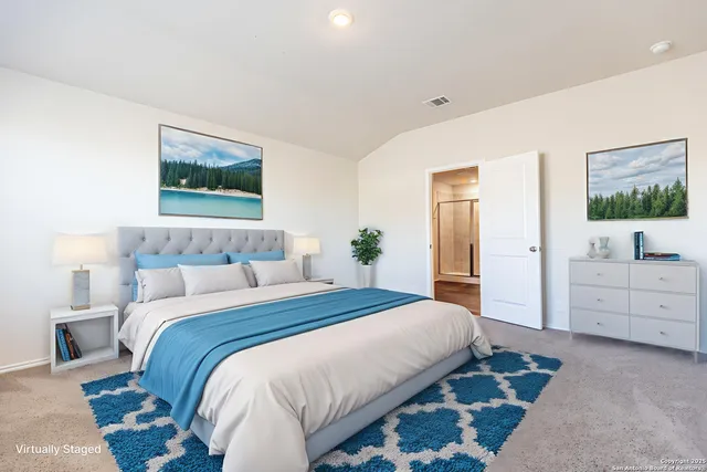 a spacious bedroom with a bed and a view of bathroom