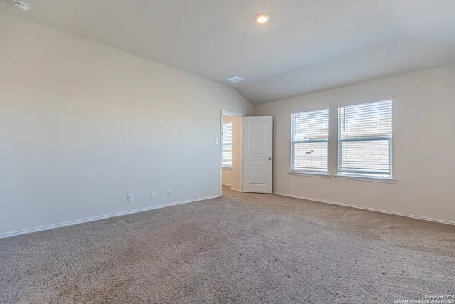 an empty room with windows and closet