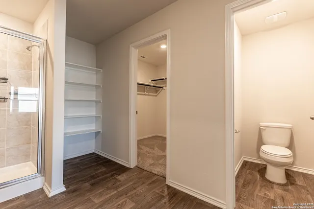 a bathroom with a toilet and a shower