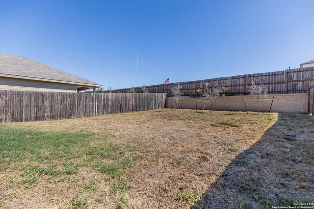 a front view of house with a garden