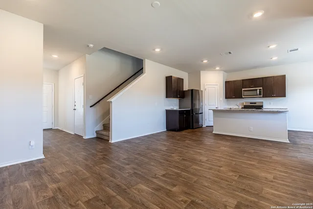 a view of kitchen with microwave and cabinets
