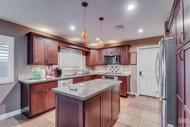 a kitchen with a stove sink and refrigerator