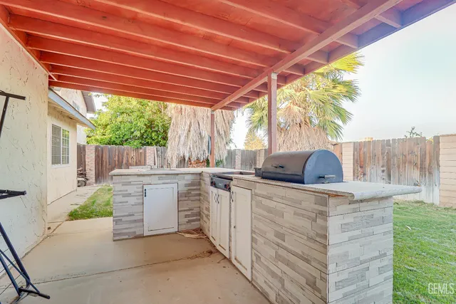 a view of a kitchen with a sink and outdoor seating