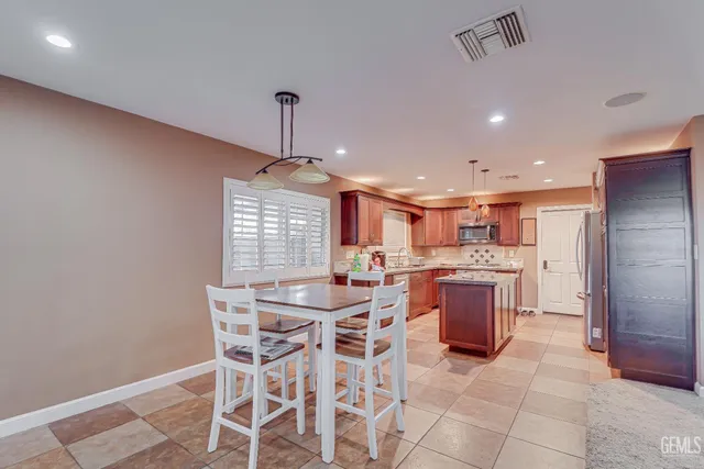 a large kitchen with a table and chairs