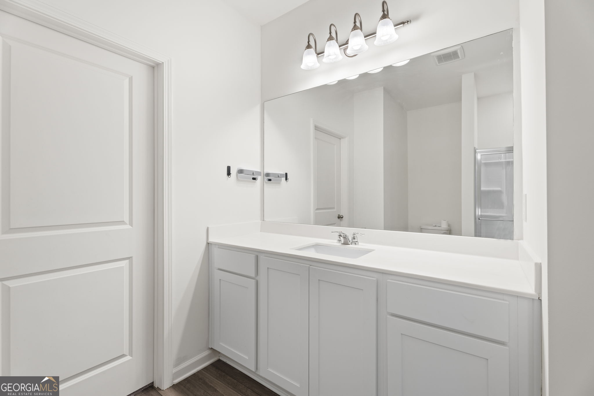 119 Bantry Way Locust Grove, GA 30248 - Photo 17 of 34 a bathroom with a sink vanity and a mirror