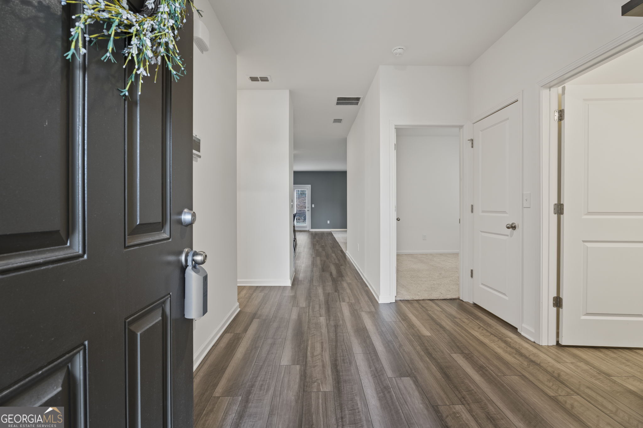 119 Bantry Way Locust Grove, GA 30248 - Photo 2 of 34 a view of a hallway with wooden floor and staircase