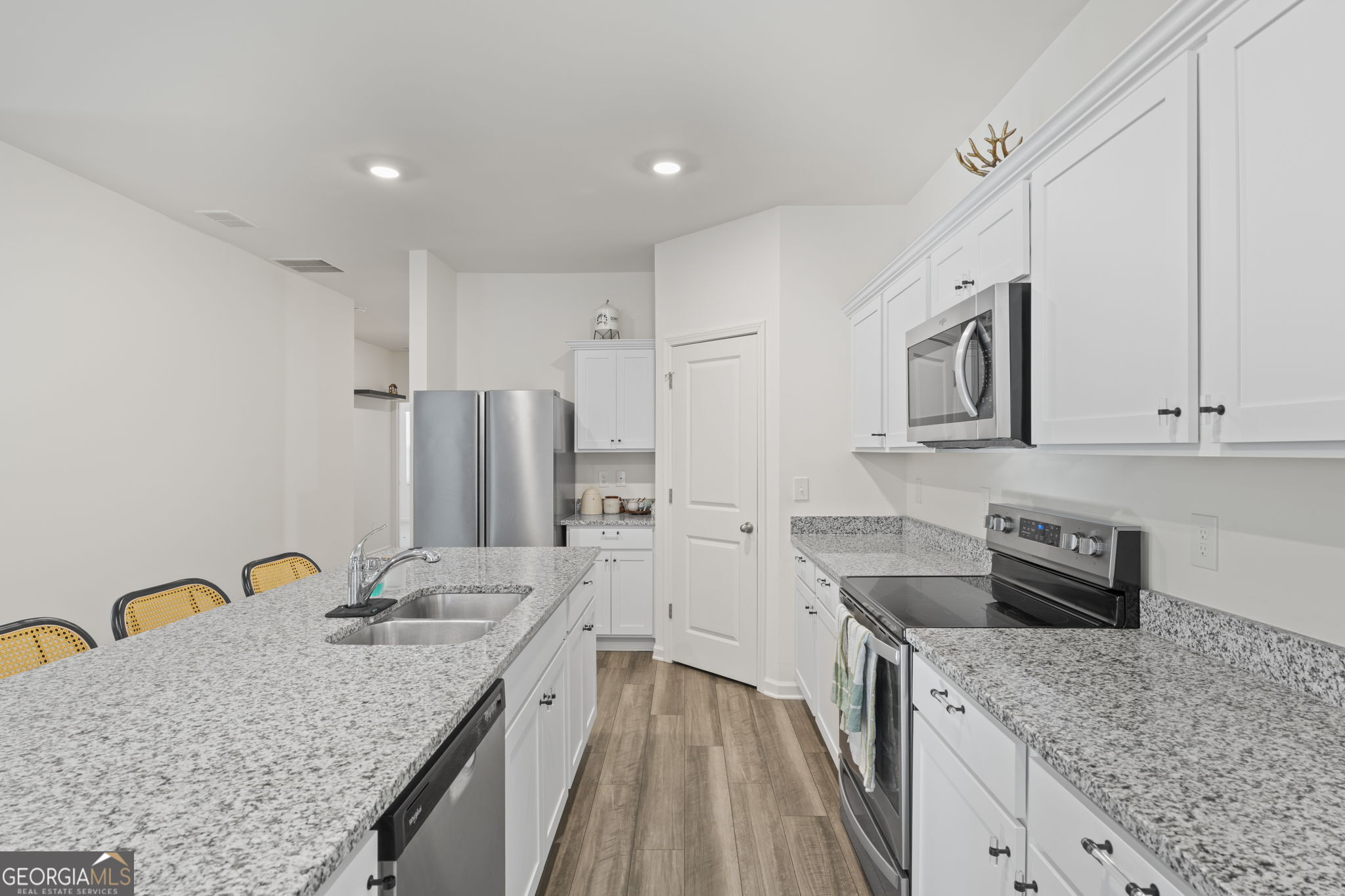 119 Bantry Way Locust Grove, GA 30248 - Photo 4 of 34 a kitchen with granite countertop a sink a counter space appliances and cabinets