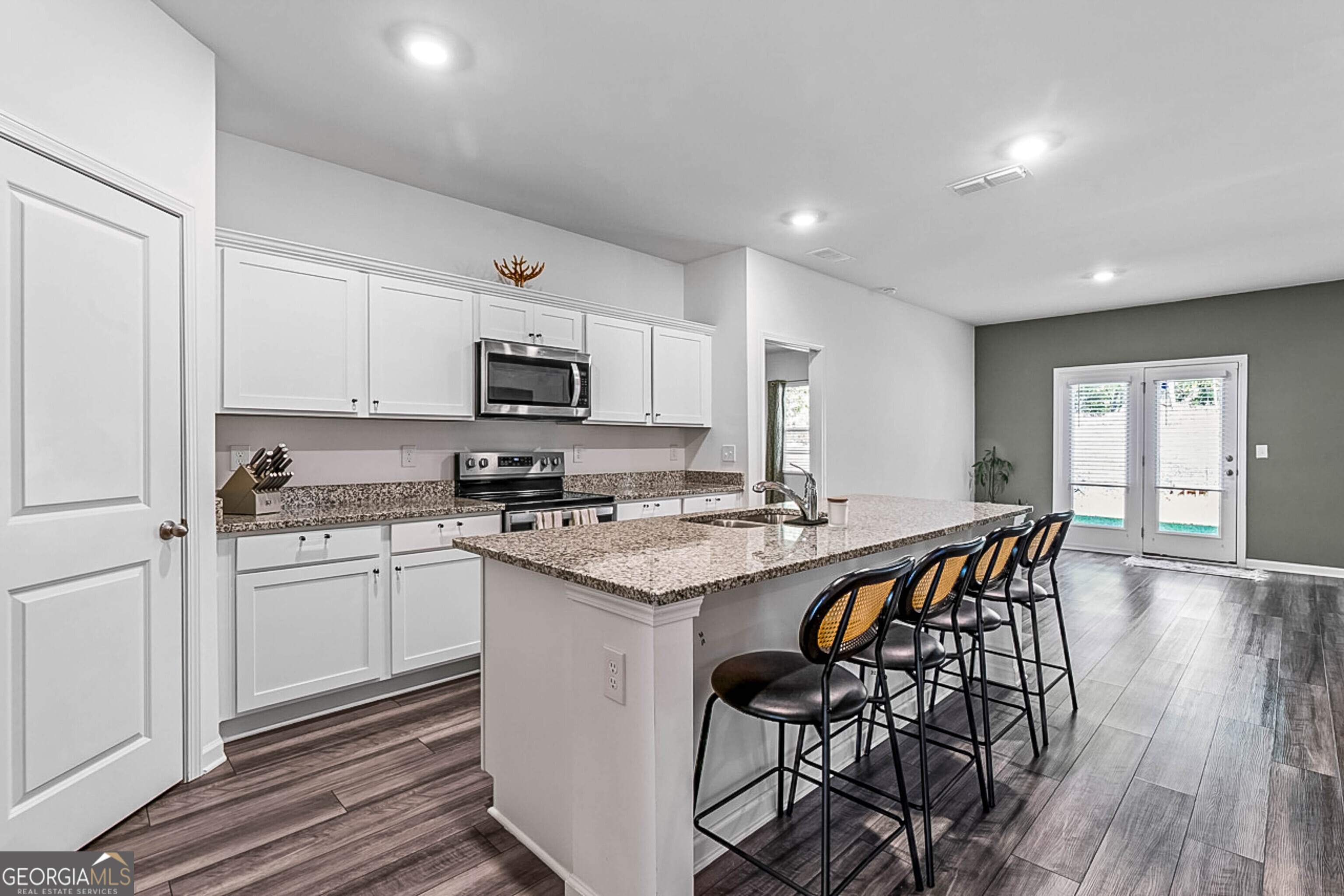 119 Bantry Way Locust Grove, GA 30248 - Photo 6 of 34 a kitchen with stainless steel appliances granite countertop a stove a sink dishwasher a microwave oven and a refrigerator with wooden floor