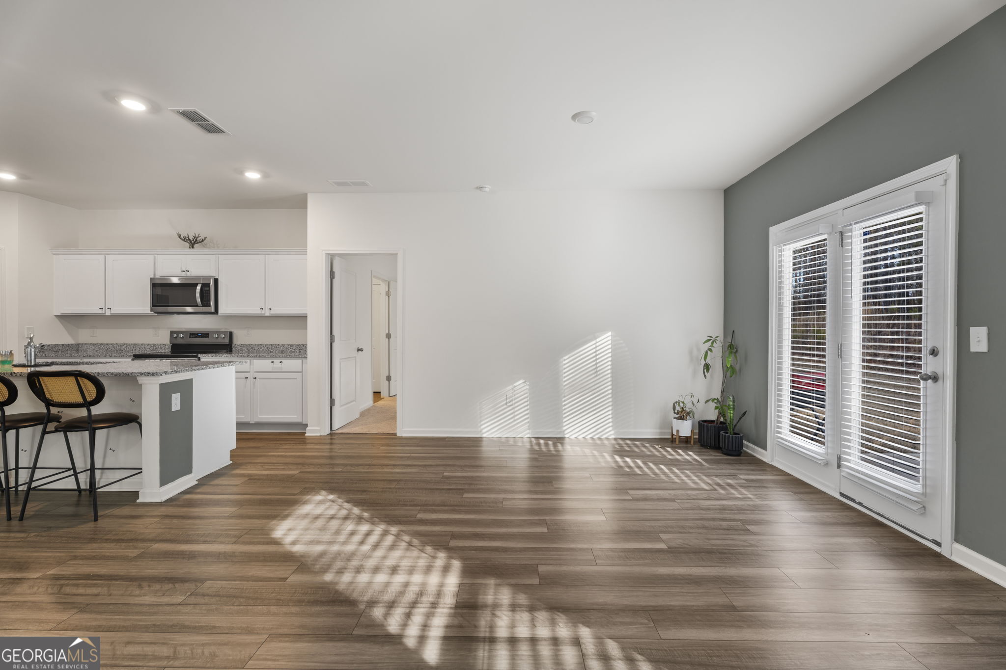 119 Bantry Way Locust Grove, GA 30248 - Photo 8 of 34 a view of kitchen with cabinets and wooden floor