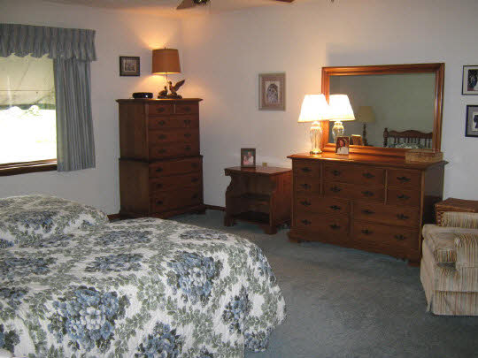 1210 Sequoia Road Rockford, IL 61108 - Photo 8 of 11 a bedroom with a bed and a table in it
