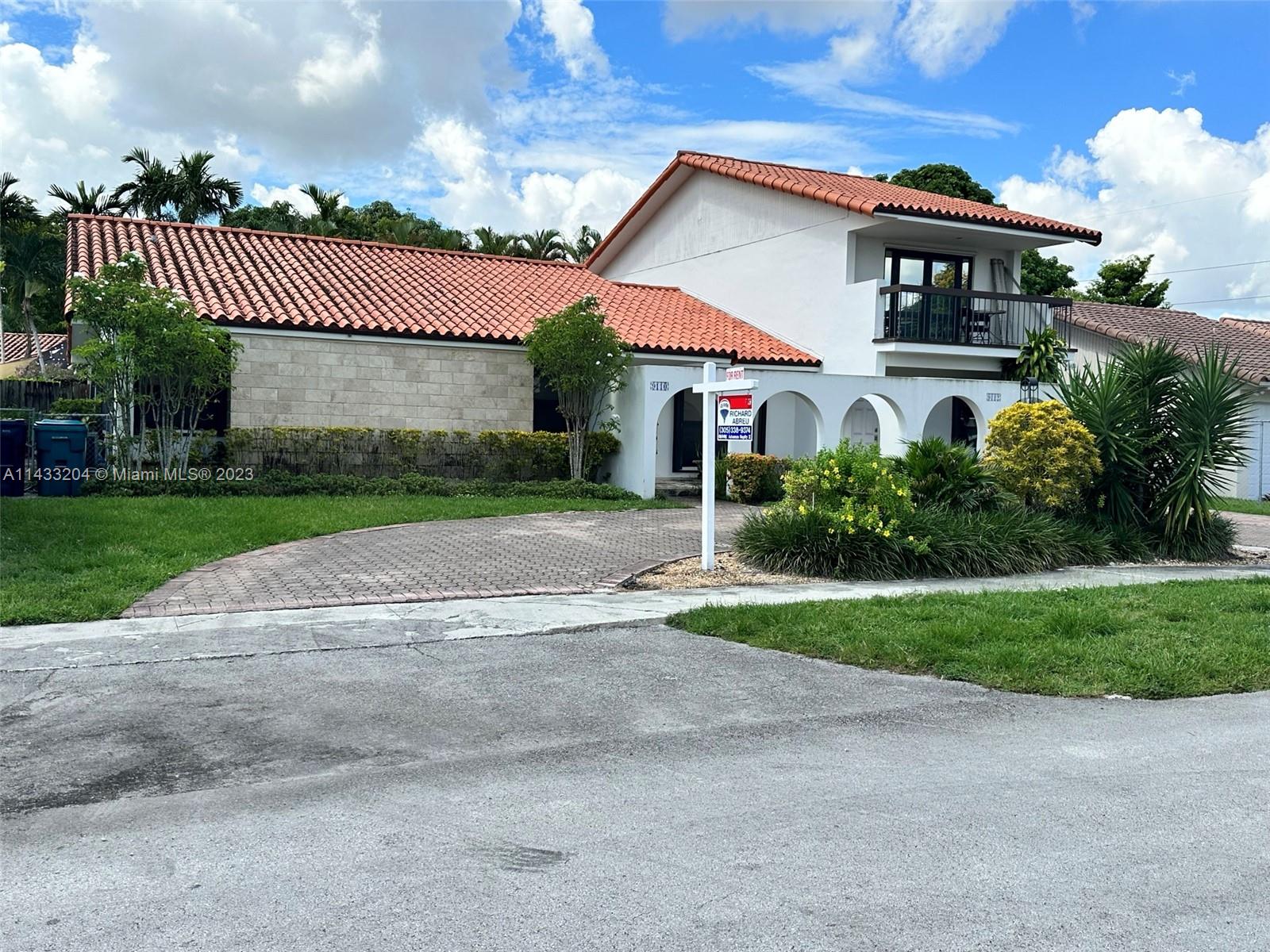 9110 Southwest 9th Terrace, Unit 9110 Miami, FL 33174 - Photo 1 of 17 a view of a house with a yard and plants
