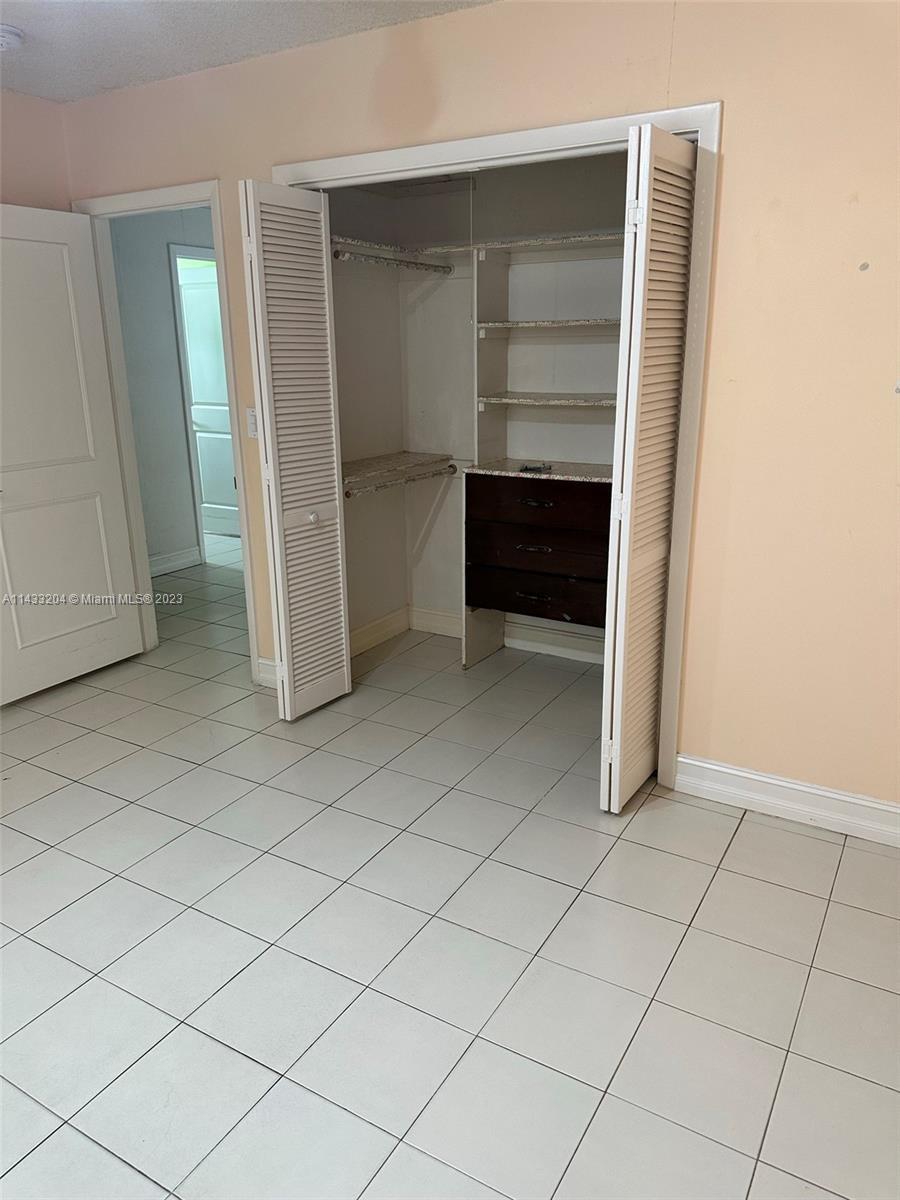 9110 Southwest 9th Terrace, Unit 9110 Miami, FL 33174 - Photo 11 of 17 a view of an empty room and closet
