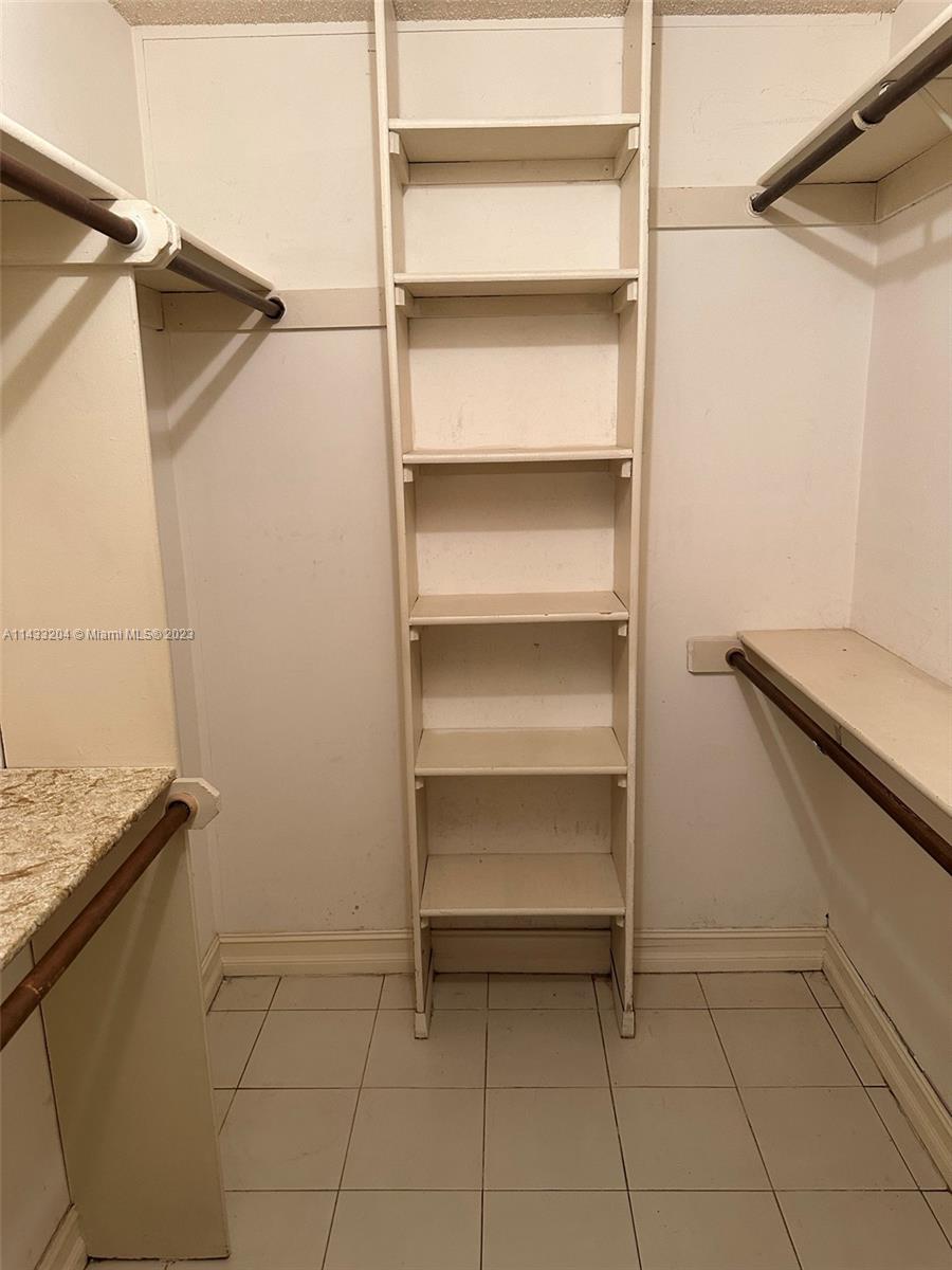 9110 Southwest 9th Terrace, Unit 9110 Miami, FL 33174 - Photo 12 of 17 a view of walk in closet with empty racks