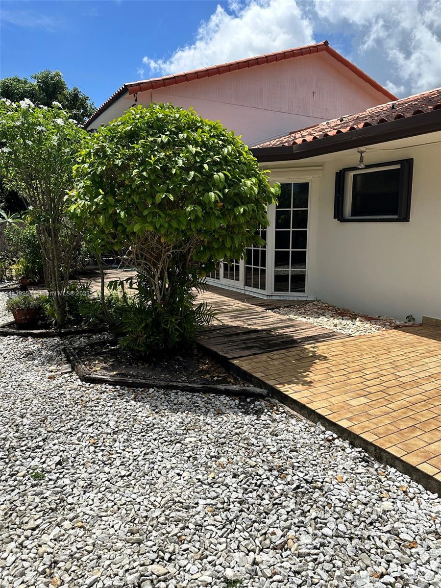 9110 Southwest 9th Terrace, Unit 9110 Miami, FL 33174 - Photo 2 of 17 a front view of a house with a yard