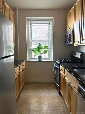 a kitchen with white cabinets and a stove top oven