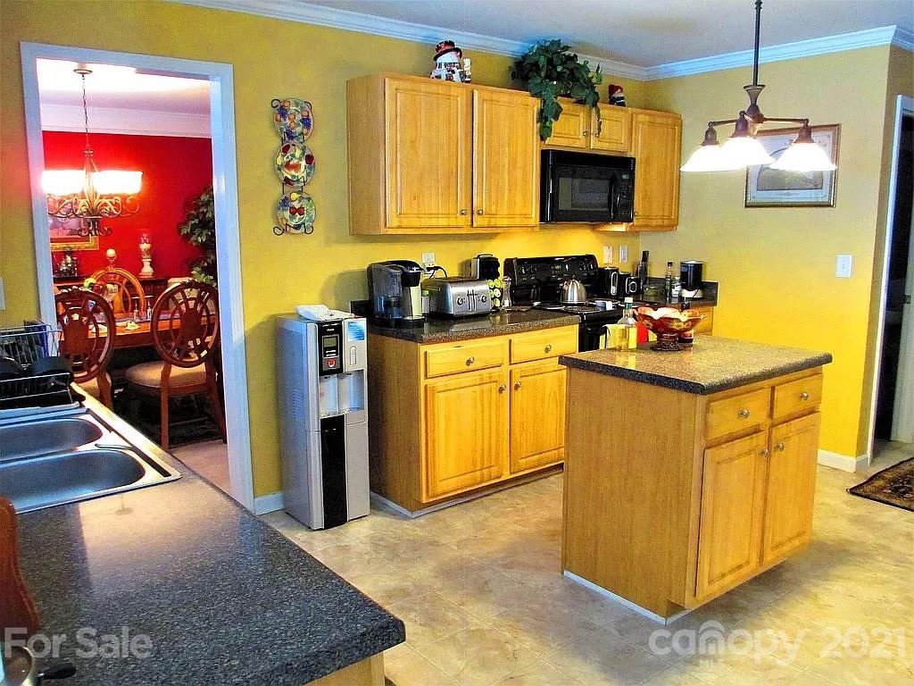 135 Scanlon Road Mooresville, NC 28115 - Photo 12 of 23 a kitchen with stainless steel appliances granite countertop a sink stove and refrigerator
