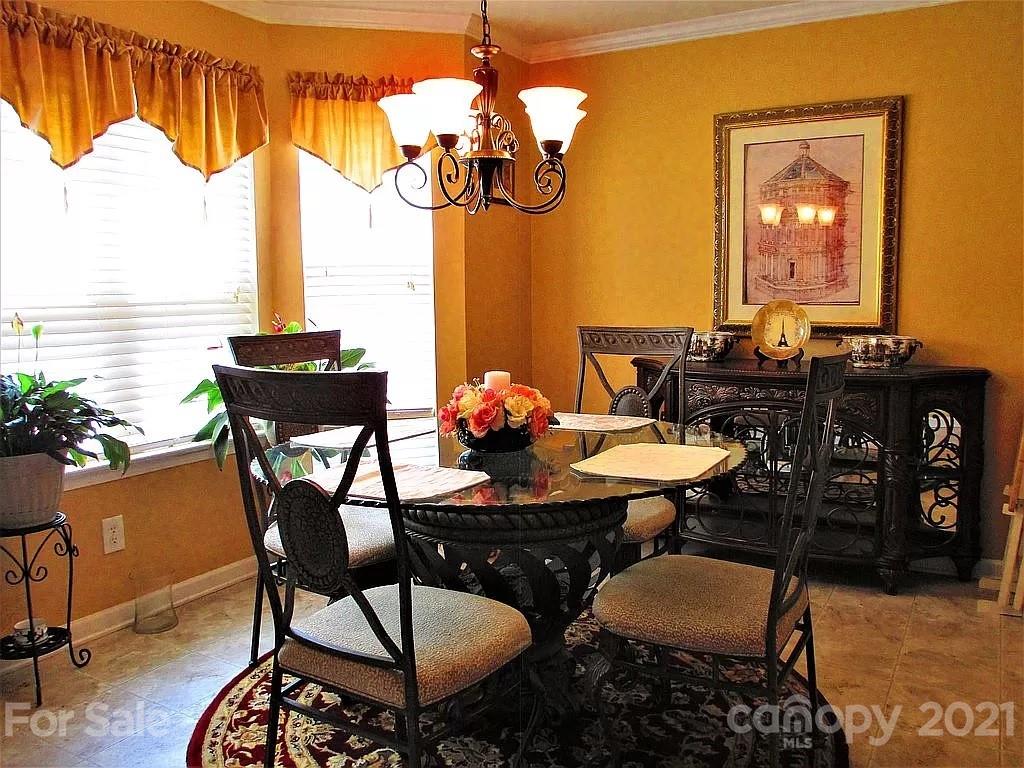 135 Scanlon Road Mooresville, NC 28115 - Photo 14 of 23 a view of a dining room with furniture and chandelier