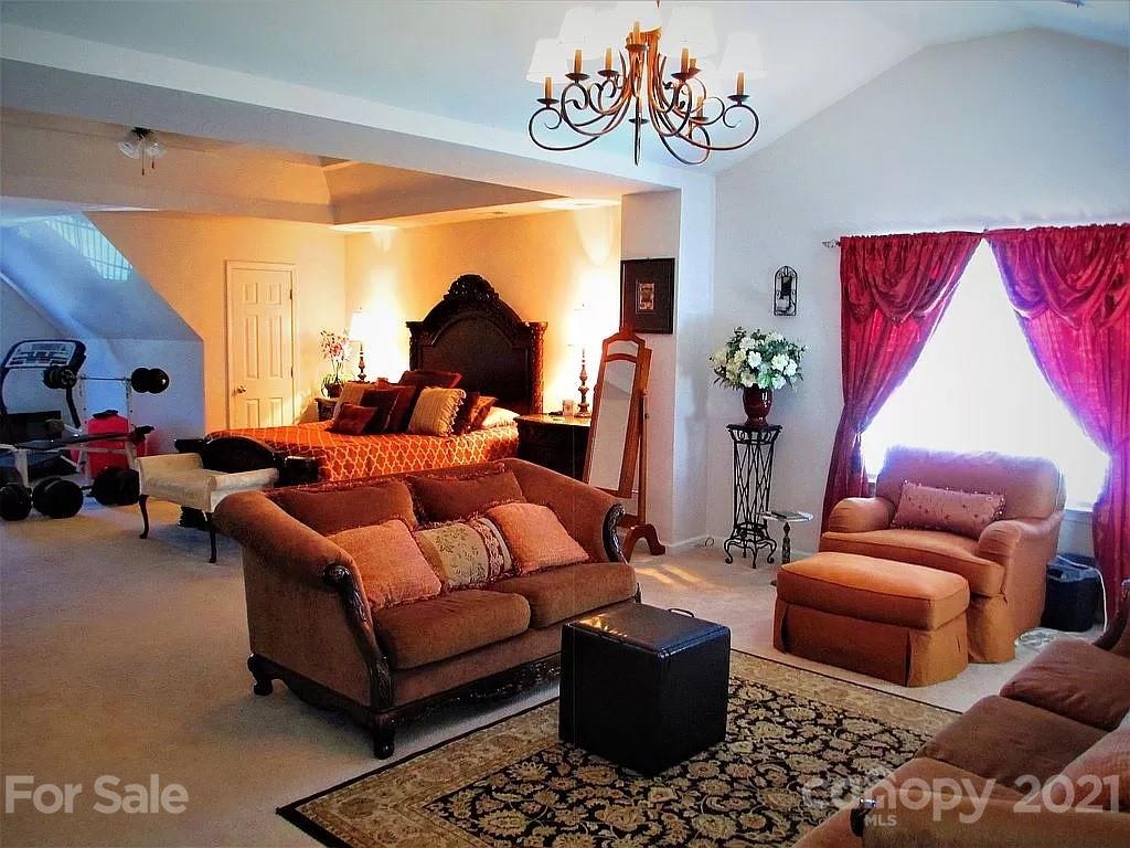 135 Scanlon Road Mooresville, NC 28115 - Photo 17 of 23 a living room with furniture a rug and a chandelier