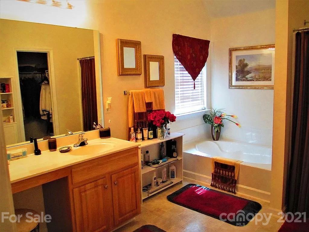 135 Scanlon Road Mooresville, NC 28115 - Photo 18 of 23 a bathroom with a granite countertop sink and a mirror