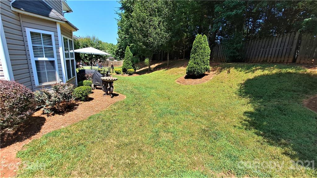 135 Scanlon Road Mooresville, NC 28115 - Photo 5 of 23 a garden with trees in front of it