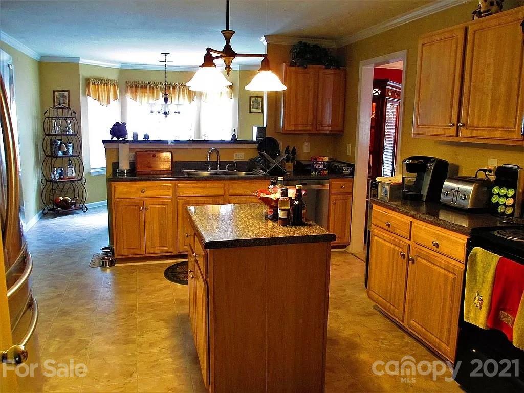 135 Scanlon Road Mooresville, NC 28115 - Photo 10 of 23 a kitchen with stainless steel appliances granite countertop a sink stove and refrigerator