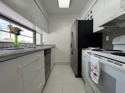 a kitchen with a stove and a refrigerator