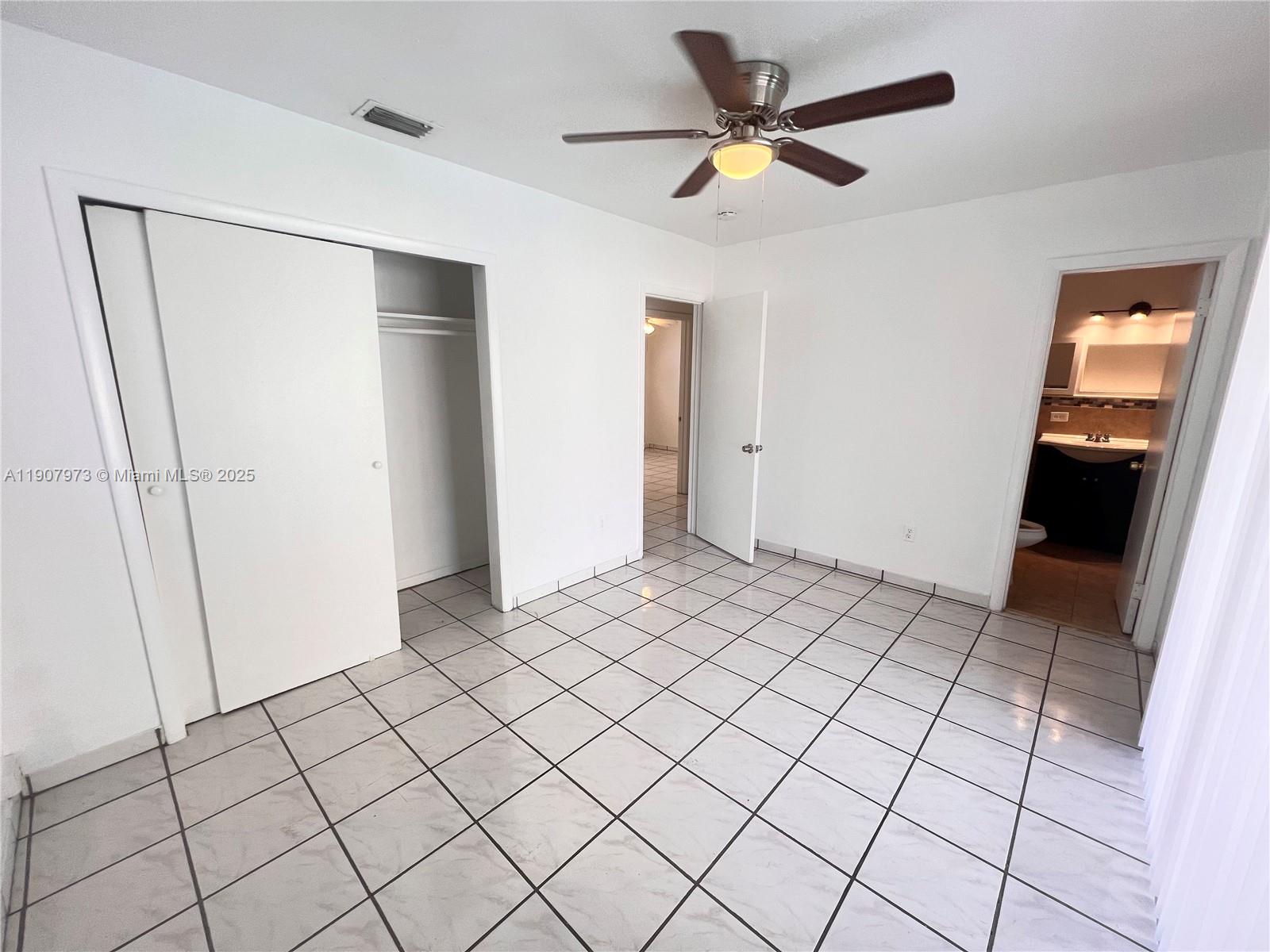 10005 Southwest 214th Street, Unit 10005 Cutler Bay, FL 33189 - Photo 12 of 22 a view of an empty room