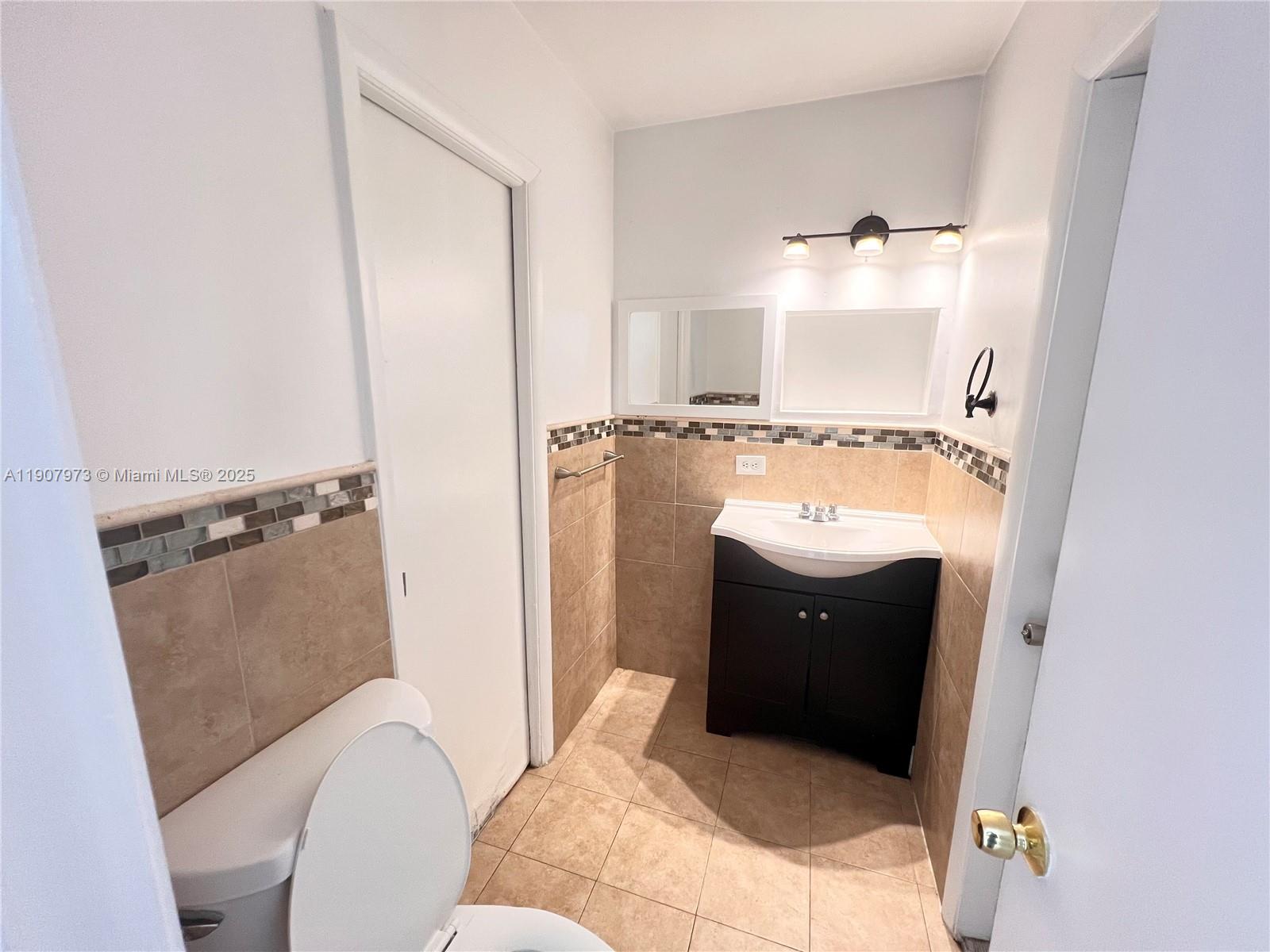 10005 Southwest 214th Street, Unit 10005 Cutler Bay, FL 33189 - Photo 13 of 22 a bathroom with a sink and toilet