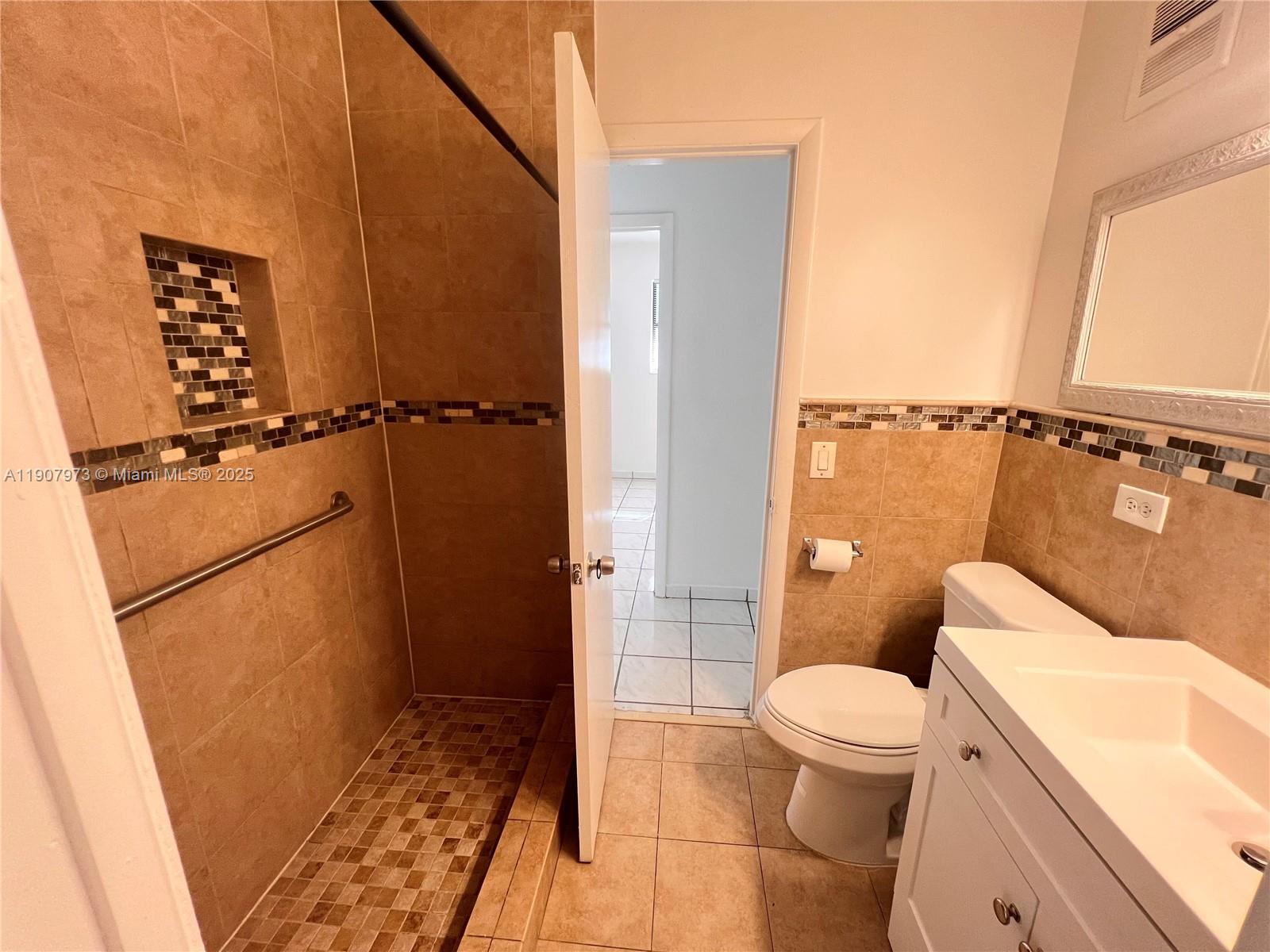 10005 Southwest 214th Street, Unit 10005 Cutler Bay, FL 33189 - Photo 14 of 22 a bathroom with a toilet and a shower