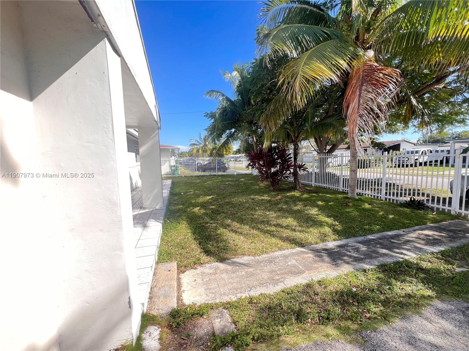 10005 Southwest 214th Street, Unit 10005 Cutler Bay, FL 33189 - Photo 19 of 22 a view of a yard with palm trees