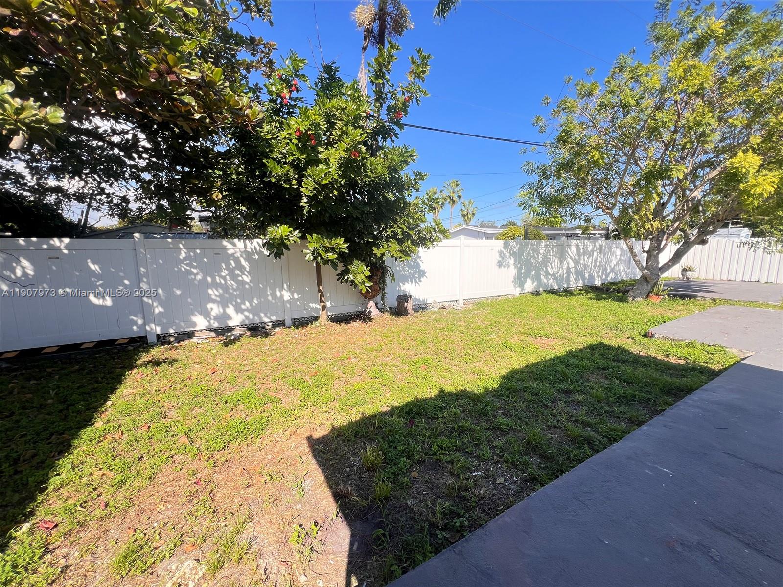 10005 Southwest 214th Street, Unit 10005 Cutler Bay, FL 33189 - Photo 21 of 22 a view of a yard with yellow house