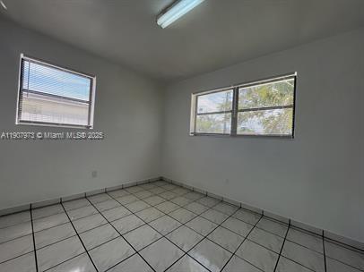 10005 Southwest 214th Street, Unit 10005 Cutler Bay, FL 33189 - Photo 4 of 22 an empty room with windows