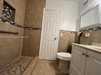 10005 Southwest 214th Street, Unit 10005 Cutler Bay, FL 33189 - Photo 7 of 22 a bathroom with a sink and toilet