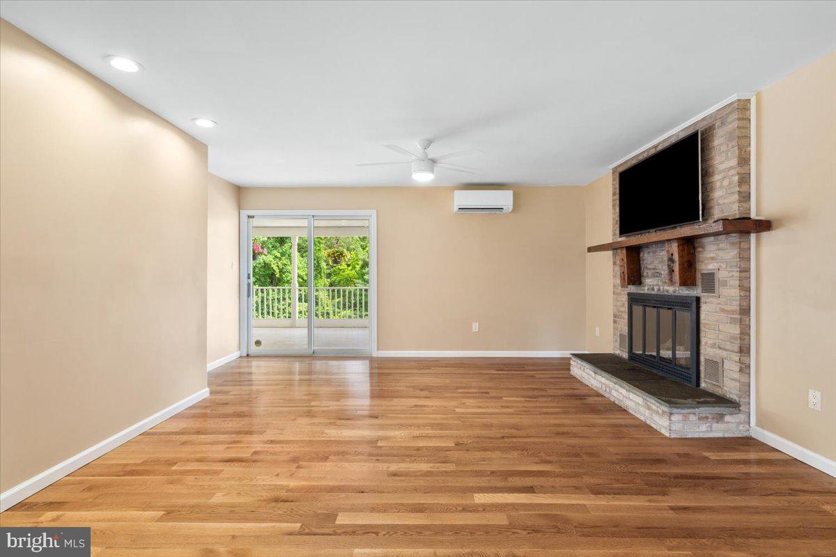 6117 Long Branch Road Frederick, MD 21701 - Photo 13 of 75 a view of empty room with wooden floor and fireplace