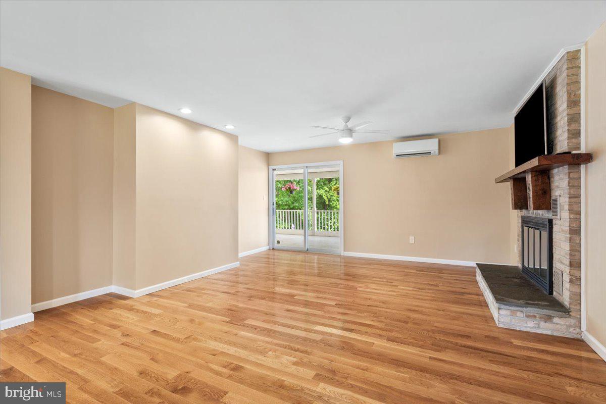 6117 Long Branch Road Frederick, MD 21701 - Photo 14 of 75 a view of an empty room with a window and wooden floor