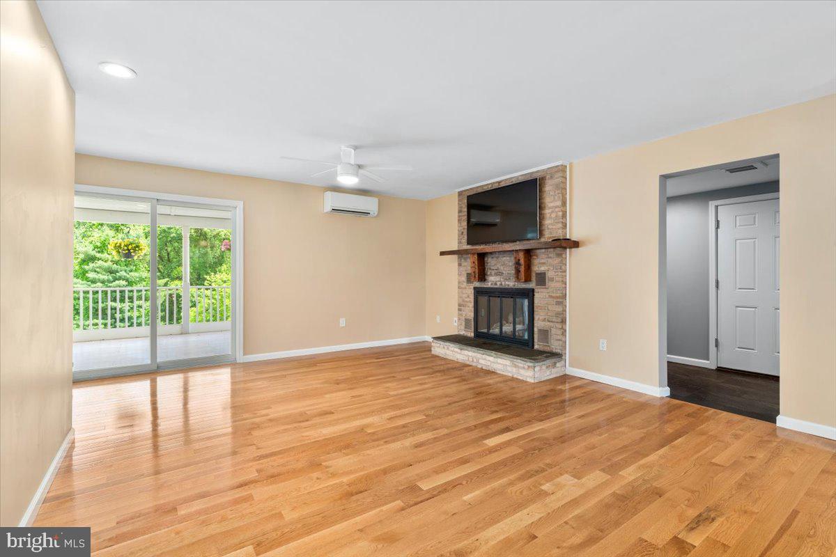 6117 Long Branch Road Frederick, MD 21701 - Photo 16 of 75 a view of empty room with wooden floor and fireplace