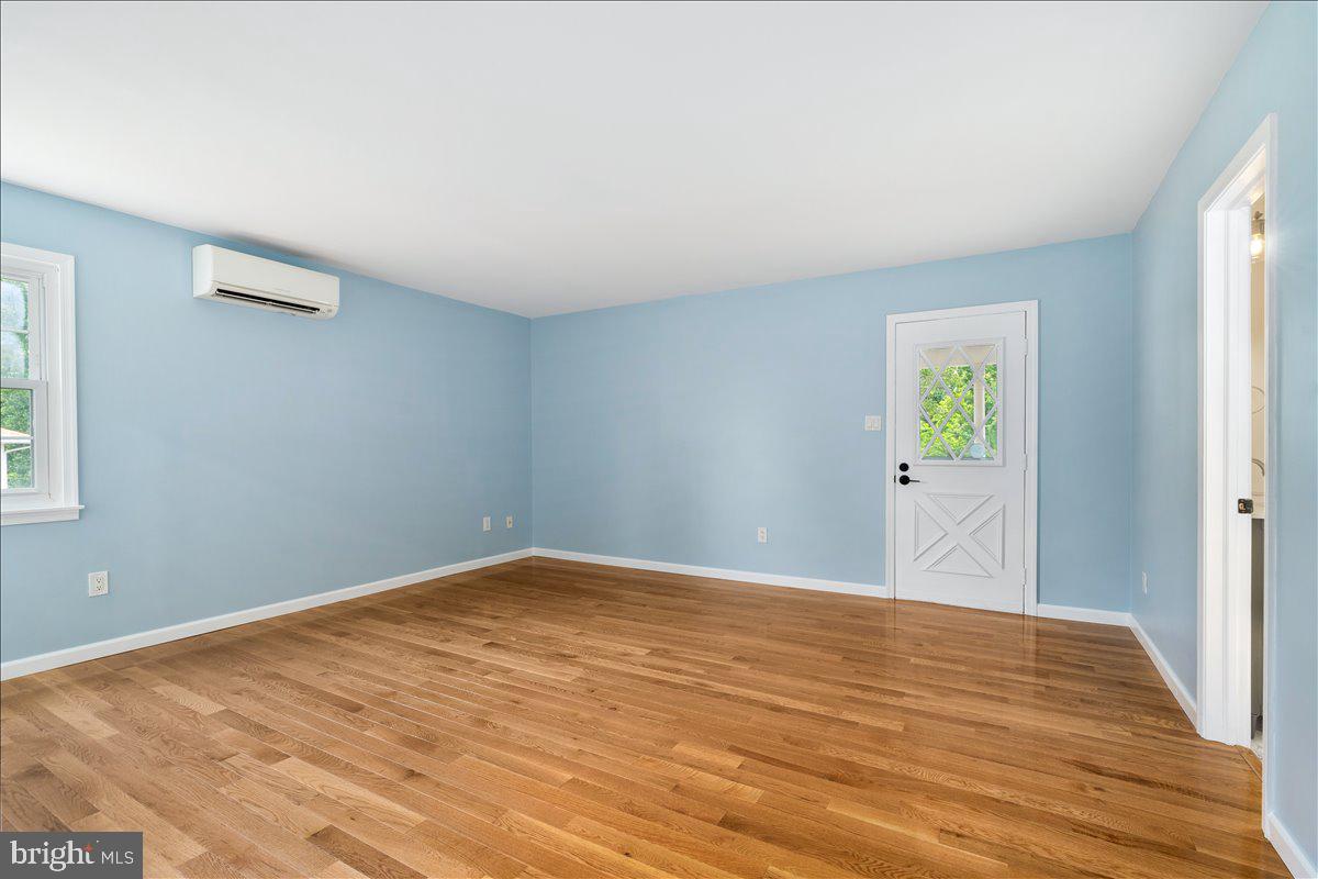 6117 Long Branch Road Frederick, MD 21701 - Photo 19 of 75 a view of an empty room with wooden floor and a window