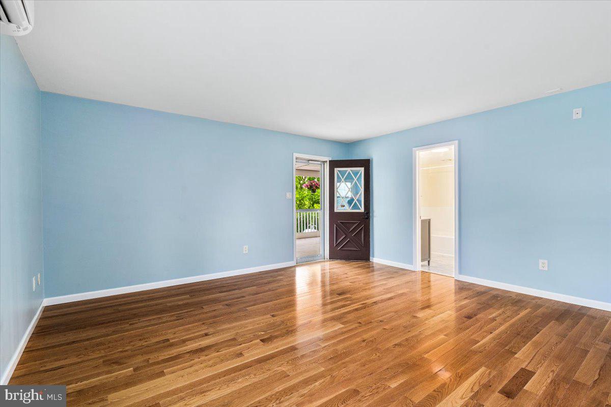 6117 Long Branch Road Frederick, MD 21701 - Photo 21 of 75 a view of an empty room with window and wooden floor